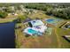 Aerial view showcasing the community pool, tennis courts, parking, and surrounding neighborhood at 2650 Einwood Dr, Kissimmee, FL 34758