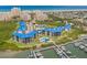 Expansive aerial view of waterfront condominiums with community pool, marina, and nearby beach at 2700 N Peninsula Ave # 215, New Smyrna Beach, FL 32169