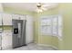 Bright kitchen features stainless steel refrigerator and plantation shutters at 2700 N Peninsula Ave # 215, New Smyrna Beach, FL 32169