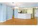 Light and bright living room leading to the kitchen with modern appliances at 2700 N Peninsula Ave # 215, New Smyrna Beach, FL 32169