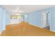 Bright living room features bamboo flooring, light blue walls, and an open floor plan with a pass-through to kitchen at 2700 N Peninsula Ave # 215, New Smyrna Beach, FL 32169