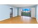 Inviting living space featuring a sliding glass door with community pool view and plank flooring at 2700 N Peninsula Ave # 215, New Smyrna Beach, FL 32169