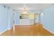Spacious open concept living room with plank floors and a view of the updated kitchen at 2700 N Peninsula Ave # 215, New Smyrna Beach, FL 32169