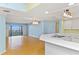 Bright, open concept living area with updated kitchen featuring stylish counters and hardwood floors at 2700 N Peninsula Ave # 215, New Smyrna Beach, FL 32169