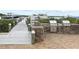 Outdoor grills set in a brick surround, adjacent to the community dock at 2700 N Peninsula Ave # 215, New Smyrna Beach, FL 32169