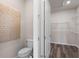 Bathroom featuring a toilet, small storage area, and a decorative wall hanging at 2749 Serenity Meadow Dr, Kissimmee, FL 34744