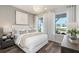 Comfortable bedroom with ample natural light, stylish furnishings, and vinyl plank flooring at 2749 Serenity Meadow Dr, Kissimmee, FL 34744