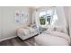 Bright bedroom featuring two twin beds, a window view, and stylish decor at 2749 Serenity Meadow Dr, Kissimmee, FL 34744
