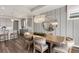 Open-concept dining area with elegant chandelier and modern gray cabinetry at 2749 Serenity Meadow Dr, Kissimmee, FL 34744
