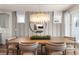 Dining room features modern chandelier, window views and a gray accent wall at 2749 Serenity Meadow Dr, Kissimmee, FL 34744