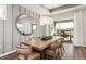 Chic dining room with stylish chandelier, modern table setting, and sliding glass doors to outdoor patio at 2749 Serenity Meadow Dr, Kissimmee, FL 34744