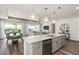 Kitchen with stone countertops, a stainless steel dishwasher, and view to living and dining areas at 2749 Serenity Meadow Dr, Kissimmee, FL 34744