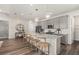 Bright kitchen features stainless steel appliances, gray cabinets, granite countertops and three globe pendant lights at 2749 Serenity Meadow Dr, Kissimmee, FL 34744