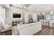 Open-concept living room with a large sofa, TV, and view of the kitchen at 2749 Serenity Meadow Dr, Kissimmee, FL 34744
