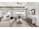 Living room with a ceiling fan, large window, and modern decor at 2749 Serenity Meadow Dr, Kissimmee, FL 34744