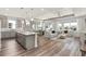 Open-concept living space showcasing a kitchen island, dining area, and comfortable seating at 2749 Serenity Meadow Dr, Kissimmee, FL 34744