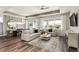 Living room with a large window, modern furniture, and a view to the dining area at 2749 Serenity Meadow Dr, Kissimmee, FL 34744