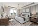 Elegant main bedroom showcasing a tray ceiling, chandelier, and plenty of natural light at 2749 Serenity Meadow Dr, Kissimmee, FL 34744