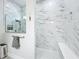 Elegant bathroom showcases a glass enclosed shower with marble tiling and a bench seat at 3182 Sailing Pier Ave, Winter Garden, FL 34787