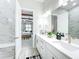 Bright bathroom with double vanity that opens to the main bedroom with ceiling beams at 3182 Sailing Pier Ave, Winter Garden, FL 34787
