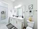 Bright and clean bathroom with double vanity, modern fixtures, and stylish decor at 3182 Sailing Pier Ave, Winter Garden, FL 34787