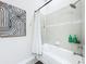 Bright bathroom with a large tub, decorative shower curtain, and stylish grey tile at 3182 Sailing Pier Ave, Winter Garden, FL 34787