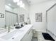 Modern bathroom with double sinks, quartz countertop, stylish fixtures, and monochrome decorative accents at 3182 Sailing Pier Ave, Winter Garden, FL 34787