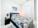 Bright bedroom featuring a floral-patterned bed, modern furnishings, and a closet at 3182 Sailing Pier Ave, Winter Garden, FL 34787