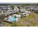 A beautiful community pool and playground are surrounded by palm trees at 3182 Sailing Pier Ave, Winter Garden, FL 34787
