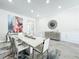 Bright dining room with statement wall art, modern lighting, and a stylish area rug at 3182 Sailing Pier Ave, Winter Garden, FL 34787