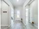 Bright foyer featuring wood-look tile flooring, white walls, and a decorative glass front door at 3182 Sailing Pier Ave, Winter Garden, FL 34787