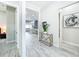 Hallway featuring wood-look tile flooring, neutral walls, and views into the dining and living areas at 3182 Sailing Pier Ave, Winter Garden, FL 34787