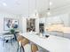 Bright kitchen boasts an island with seating, pantry, stainless appliances, and modern pendant lighting at 3182 Sailing Pier Ave, Winter Garden, FL 34787