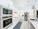 Modern kitchen with stainless steel appliances, white cabinets, modern backsplash, and countertops at 3182 Sailing Pier Ave, Winter Garden, FL 34787