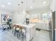 Bright kitchen with white cabinets, pendant lighting, and a breakfast bar island with seating at 3182 Sailing Pier Ave, Winter Garden, FL 34787