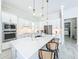 Modern kitchen featuring white cabinets, stainless steel appliances, and a large center island with seating at 3182 Sailing Pier Ave, Winter Garden, FL 34787