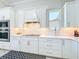 Bright kitchen with white cabinets, stainless steel appliances, modern backsplash, and countertop at 3182 Sailing Pier Ave, Winter Garden, FL 34787