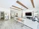 Open-concept living room with a marble fireplace, wood beam ceilings and decor shelving at 3182 Sailing Pier Ave, Winter Garden, FL 34787