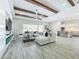 Spacious living room featuring an open floor plan, beamed ceilings, and tile floors at 3182 Sailing Pier Ave, Winter Garden, FL 34787