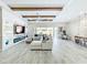 Open-concept living room with beamed ceilings, a large sectional sofa, and tile flooring at 3182 Sailing Pier Ave, Winter Garden, FL 34787