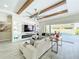 Bright living room with wood-beam ceiling, fireplace, built-in shelving, and access to the backyard pool at 3182 Sailing Pier Ave, Winter Garden, FL 34787