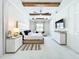 Bright main bedroom featuring tray ceiling with wood beams and wide plank flooring at 3182 Sailing Pier Ave, Winter Garden, FL 34787