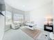 Bright home office with modern glass desk, comfortable seating, and lots of natural light from large windows at 3182 Sailing Pier Ave, Winter Garden, FL 34787