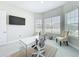 Well-lit office space features a modern glass desk, comfortable seating, and a wall-mounted television at 3182 Sailing Pier Ave, Winter Garden, FL 34787