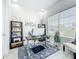 Well-lit home office with a modern desk, built-in shelving, and a comfortable seating area at 3182 Sailing Pier Ave, Winter Garden, FL 34787