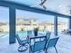Beautiful outdoor patio with a ceiling fan and a table with four chairs overlooking a swimming pool at 3182 Sailing Pier Ave, Winter Garden, FL 34787