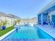 Beautiful backyard pool with sun loungers for relaxing, and a covered patio with seating for outdoor enjoyment at 3182 Sailing Pier Ave, Winter Garden, FL 34787
