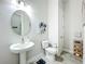 Cozy powder room features a pedestal sink, modern fixtures, and stylish decor at 3182 Sailing Pier Ave, Winter Garden, FL 34787