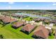 Stunning aerial shot of a residential community with lush green lawns and picturesque views of a tranquil lake at 3375 Bellino Blvd., New Smyrna Beach, FL 32168