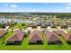 Beautiful aerial view of homes in a lakeside community featuring well-manicured lawns and serene water views at 3375 Bellino Blvd., New Smyrna Beach, FL 32168